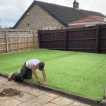 Installing fake grass in a garden in hertfordshire